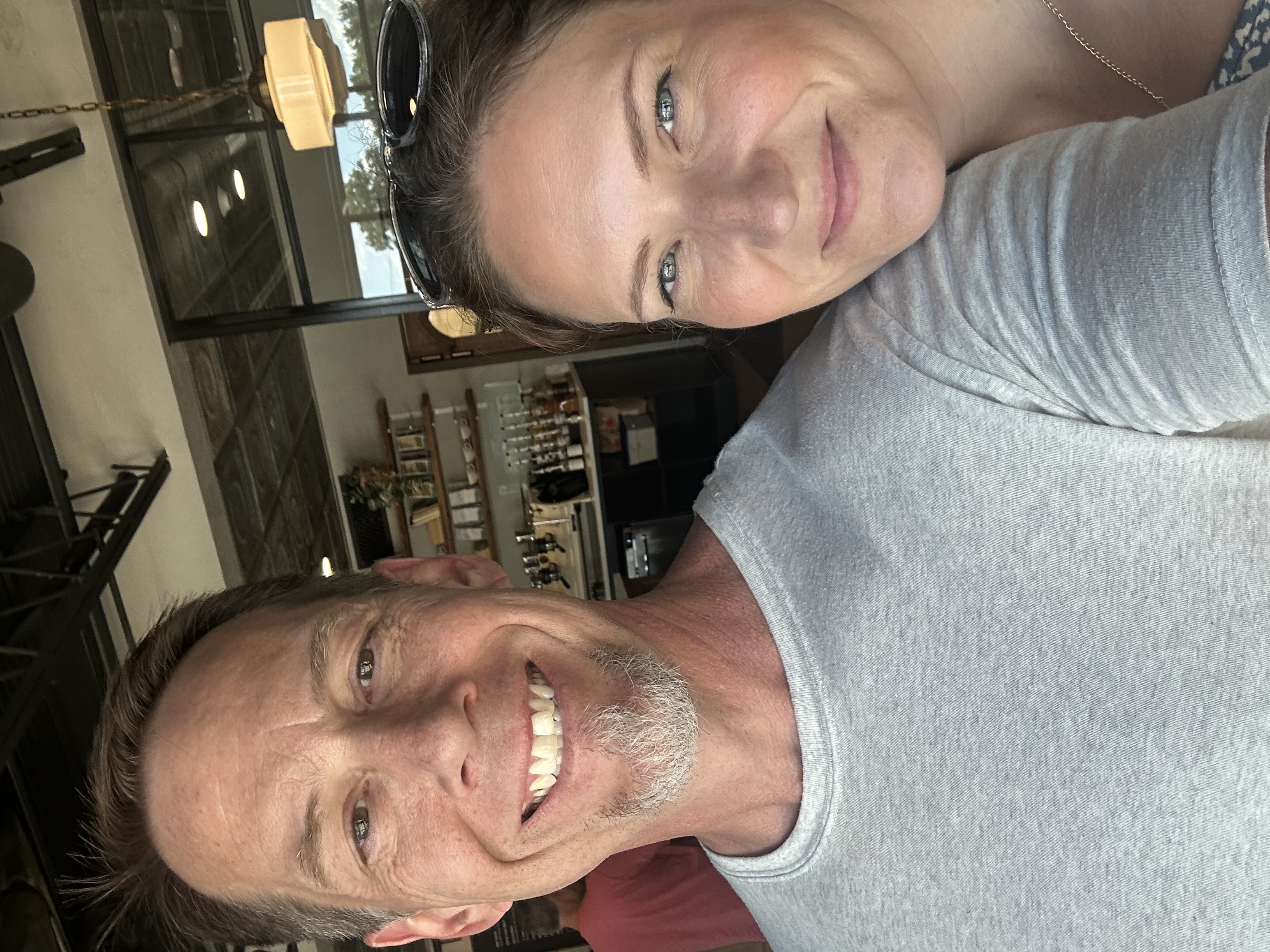 Ryan Moran and his wife Cindy taking a selfie together in a cozy cafe setting